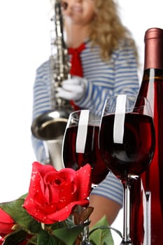 The wine bottle, two glasses, rose and the sexual girl with a saxophone.
