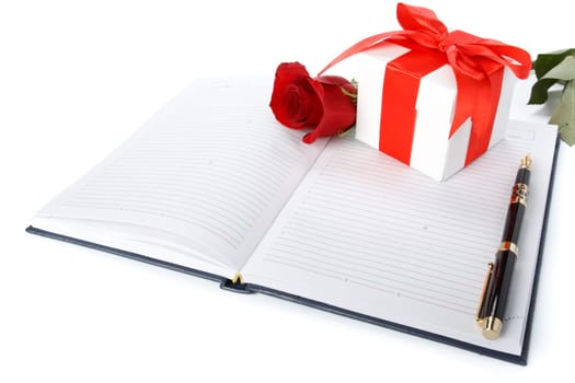Gift box, rose and organizer on a white background