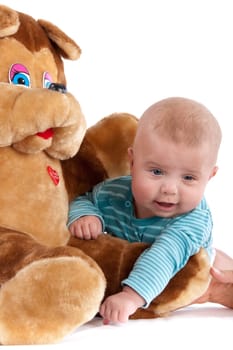 The nice small child in striped rompers with toy on a white background.