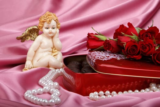 Heart-shaped red box with sweets, cupid and flowers. Valentine&#039 s day card.