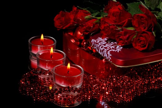 Heart-shaped red box and flowers on a black background. Valentine&#039 s day card.