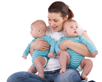 Happy young mother with two babies on a white background.