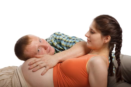 Young father listening heartbeat of his future child on a white background