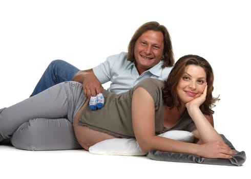 The young family expecting a birth of the child, holds bootees