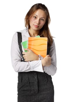 The beautiful girl stand with coloured writing-books on a white background. The student.