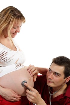 Young father listening heartbeat of his future child on a white background
