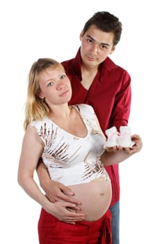 The young family expecting a birth of the child, holds bootees