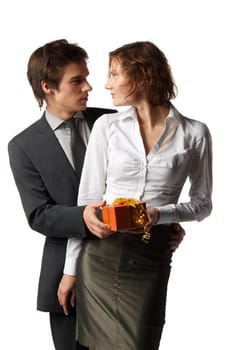The young enamoured man gives a gift to the girlfriend on a white background.