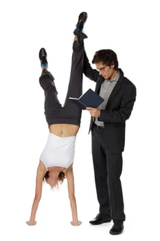 The young man with the book and the girl standing on hands on a white background.