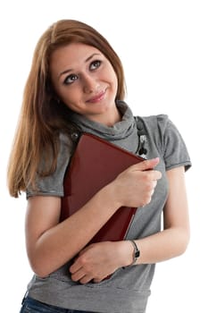 The attractive student stands with the laptop on a white background.
