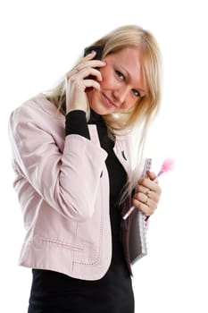 The beautiful girl stand with writing-books and mobile phone on a white background. The student.