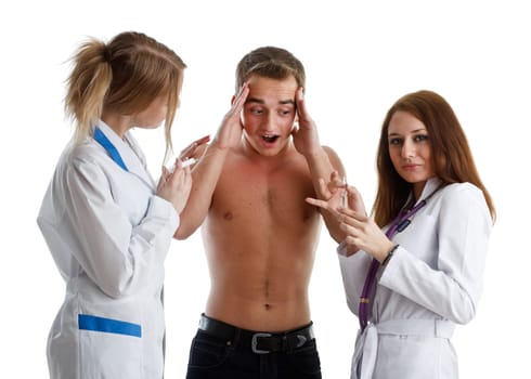 Two nurses and the young male patient on a white background.