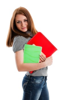The beautiful girl stand with coloured writing-books on a white background. The student.