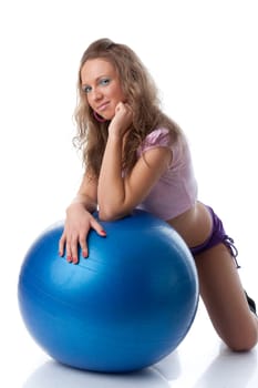 Young beautiful woman with gymnastic ball on a white background.