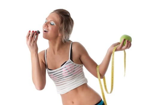 Young beautiful girl with apple and cake in her hands on a white background. Healthy food concept