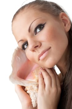 Beautiful woman listens seashell on a white background