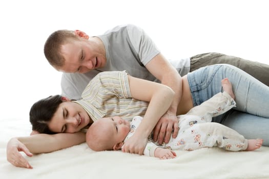 Happy family. Father, mother and sweet baby on a white background.