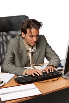 Stressed businessman looking at computer on a white background