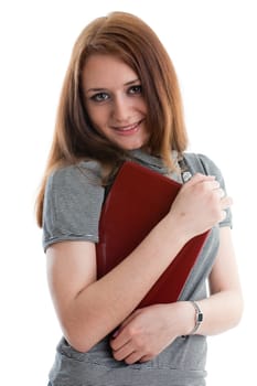 The attractive student stands with the laptop on a white background.