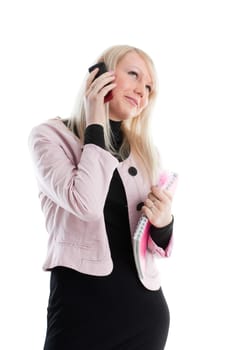 The beautiful girl stand with writing-books and mobile phone on a white background. The student.