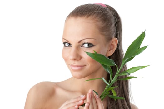 The attractive girl with a bamboo branch on a white background