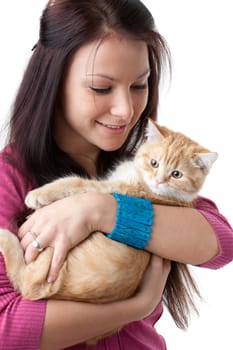 The happy young woman with a small amusing kitten on a white background.