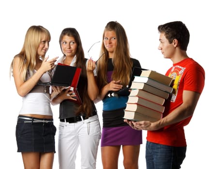 Three beautiful students with laptops discuss the young man with the big pile of books on a white background.