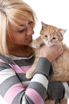 The happy young woman with a small amusing kitten on a white background.