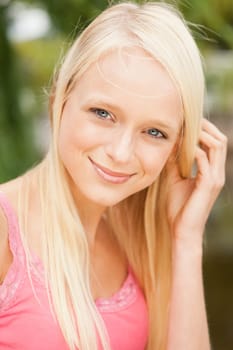 Portrait of a young and smiling woman in the park