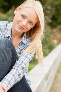 Portrait of a young and smiling woman in the park