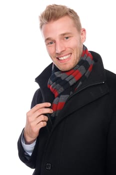 Studio shot of a young man with a scarf and a coat