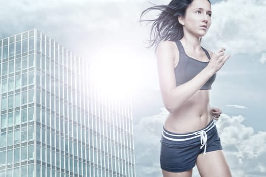 Young woman running in backlight in a city