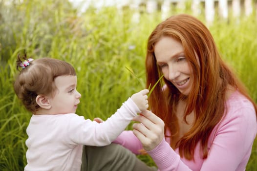 beautiful mother and baby little girl outdoor park garden grass playing