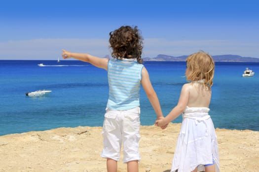 two sister girls summer Cala Saona looking blue sea Formentera Balearic