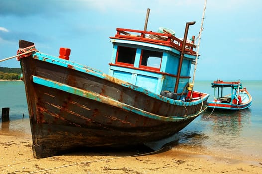 Fishermans boats on the ocean coast. Sun sand and sea.