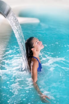 spa hydrotherapy woman waterfall jet turquoise swimming pool water