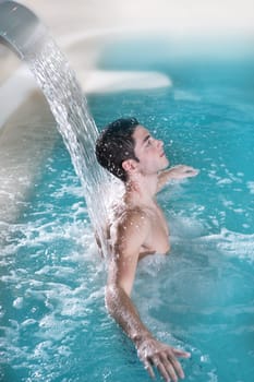 spa hydrotherapy man waterfall jet turquoise swimming pool water