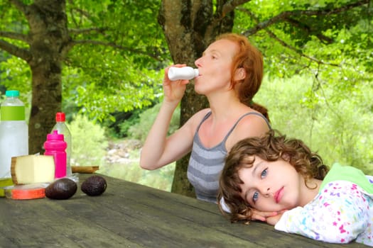 Mother daughter picnic outdoor park relaxed girl