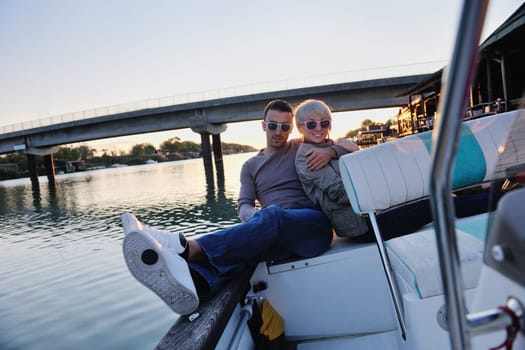 happy young couple in love  have romantic time at summer sunset   at ship boat while  representing urban and countryside fashin lifestyle