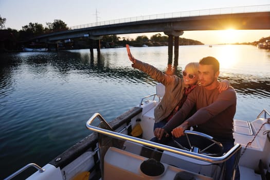 happy young couple in love  have romantic time at summer sunset   at ship boat while  representing urban and countryside fashin lifestyle