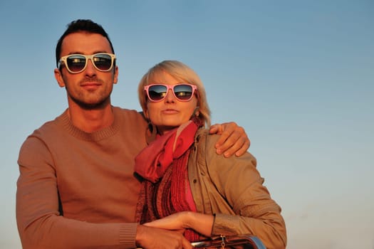 happy young couple in love  have romantic time at summer sunset   at ship boat while  representing urban and countryside fashin lifestyle