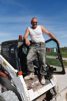 Bobcat Driver.A construction worker stands on his construction machine