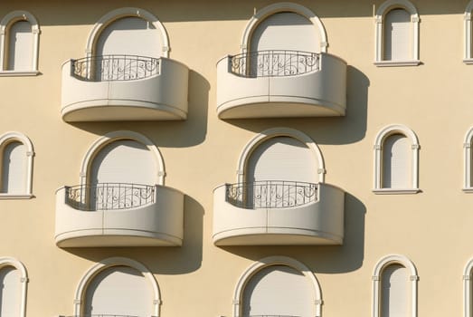windows decorated with arches on the exterior of a building