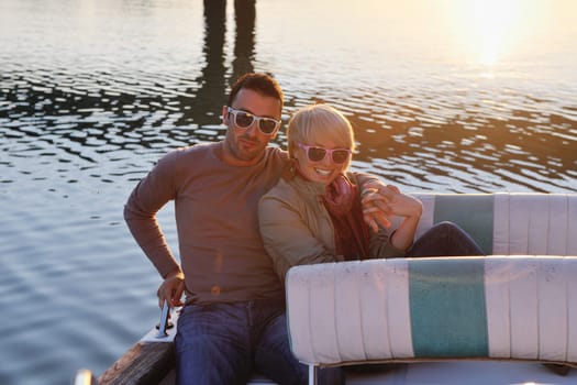 happy young couple in love  have romantic time at summer sunset   at ship boat while  representing urban and countryside fashin lifestyle