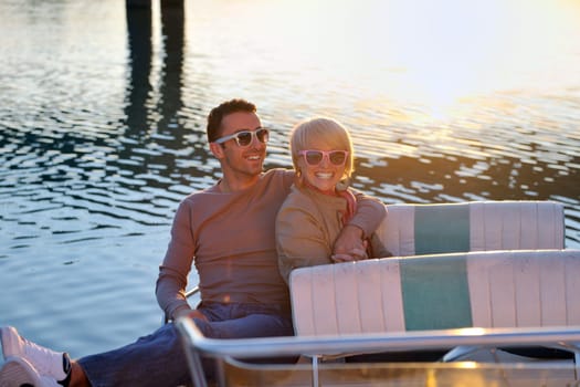 happy young couple in love  have romantic time at summer sunset   at ship boat while  representing urban and countryside fashin lifestyle