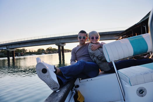 happy young couple in love  have romantic time at summer sunset   at ship boat while  representing urban and countryside fashin lifestyle