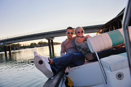 happy young couple in love  have romantic time at summer sunset   at ship boat while  representing urban and countryside fashin lifestyle
