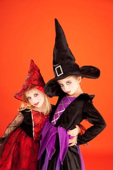 Halloween sister kid girls on orange background