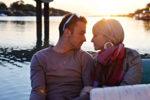 happy young couple in love  have romantic time at summer sunset   at ship boat while  representing urban and countryside fashin lifestyle