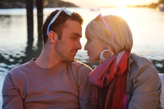 happy young couple in love  have romantic time at summer sunset   at ship boat while  representing urban and countryside fashin lifestyle